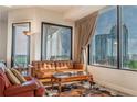 Inviting living room with city views, comfortable seating, and stylish decor at 2828 Peachtree Nw Rd # 1501, Atlanta, GA 30305