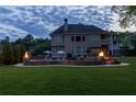 Spacious backyard features a pool, patio, fire bowls, grill, and well-maintained lawn at 440 Scott Farm Dr, Powder Springs, GA 30127