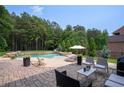 Backyard oasis with a swimming pool, lounge chairs, and lush landscaping at 440 Scott Farm Dr, Powder Springs, GA 30127
