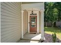 Charming front door entrance with covered porch and detailed trim work at 562 Poplar Bnd, Canton, GA 30114