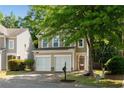 Inviting home exterior with a double garage, tree, and well-kept lawn at 562 Poplar Bnd, Canton, GA 30114
