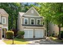 Traditional two-story home featuring an attached garage and lush landscaping at 562 Poplar Bnd, Canton, GA 30114