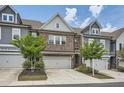 Attractive townhome showcasing a brick exterior, well-maintained landscaping, and a convenient two-car garage at 2543 Oakbourne Ln # 14, Smyrna, GA 30080