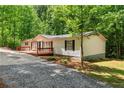 Well-maintained single-story home with a spacious wooden deck and beautifully landscaped yard at 6670 George Ct, Cumming, GA 30041