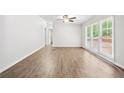 Bright living room with durable wood flooring and ample natural light from large windows at 6670 George Ct, Cumming, GA 30041