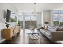 Stylish living room featuring hardwood floors, a comfortable gray sofa, and an elegant glass coffee table at 1820 Peachtree St # 614, Atlanta, GA 30309