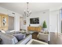 Spacious living room with hardwood floors, a modern entertainment center, and comfortable seating at 1820 Peachtree St # 614, Atlanta, GA 30309