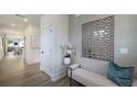 Bright hallway features wood floors, white trim and walls, a sitting bench, and tasteful decor at 1834 Butterfly Way, Marietta, GA 30066