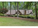 Charming brick home with lush landscaping and mature trees offering great curb appeal at 3456 Drayton Ne Dr, Roswell, GA 30075