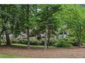 View of a home partially obscured by mature trees, providing a sense of privacy and seclusion at 3456 Drayton Ne Dr, Roswell, GA 30075