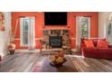 Cozy living room with a stone fireplace, hardwood floors and natural light at 1023 Bentley Estates Dr, Dacula, GA 30019
