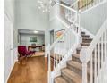 Grand foyer with hardwood floors, staircase, chandelier, and view into the office at 4027 Mount Vernon Dr, Woodstock, GA 30189