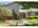 Inviting home entrance with stone path, water feature, and pergola framed by lush greenery and flag at 635 Stone Harbor Sw Pkwy, Marietta, GA 30060