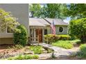 Charming home entrance features a welcoming stone pathway, lush landscaping, and a pergola covered porch at 635 Stone Harbor Sw Pkwy, Marietta, GA 30060