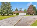 Single story home featuring a large driveway, front yard, and a two car garage at 95 Stephens Dr, Covington, GA 30016