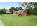 Lovely brick home featuring a spacious lawn and landscaping that offers great curb appeal at 124 Crown Walk, Mcdonough, GA 30253