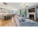 Open-concept living room with a fireplace, leading into a modern kitchen and dining space at 2624 Chase Rdg, Kennesaw, GA 30144