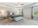 Spacious main bedroom featuring a tray ceiling, carpet flooring, and bright natural light at 2624 Chase Rdg, Kennesaw, GA 30144