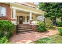 Beautiful brick steps lead to the front door, framed by lush landscaping and charming planter boxes at 1095 Saint Charles Ne Pl, Atlanta, GA 30306