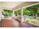 Inviting front porch with brick flooring, classic columns, and a relaxing porch swing at 1095 Saint Charles Ne Pl, Atlanta, GA 30306