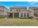 Backyard view featuring a covered patio and green lawn at 2320 Ivy Birch Ln, Buford, GA 30519