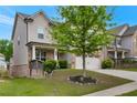 Charming two-story home featuring a stone facade, covered porch, and beautifully landscaped front yard at 2320 Ivy Birch Ln, Buford, GA 30519