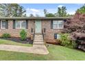 Inviting brick home with a light-blue front door, landscaped garden, and well-kept lawn at 2653 Elkhart Sw Cir, Marietta, GA 30064