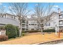 Exterior view of the residential complex with well-manicured lawns and mature trees at 4100 Paces Se Walk # 2304, Atlanta, GA 30339