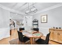 Dining room with hardwood floors, modern chandelier, with an elegant table and black chairs at 4100 Paces Se Walk # 2304, Atlanta, GA 30339