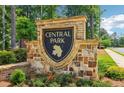 Stone sign for Central Park neighborhood with trees and landscaping at 66 Cottontail Ln, Loganville, GA 30052