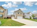 Two-story home featuring a two-car garage and an additional one-car garage at 66 Cottontail Ln, Loganville, GA 30052