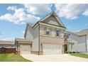 Two-story home featuring a two-car garage and an additional one-car garage at 66 Cottontail Ln, Loganville, GA 30052