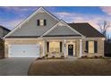 Well-maintained home featuring a brick facade, attached two-car garage, and inviting front porch area with tasteful decor at 7995 Brewton Creek Dr, Cumming, GA 30028