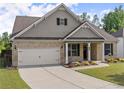 Inviting single-Gathering home with a brick and shingle exterior, showcasing a well-maintained lawn and attached two-car garage at 7995 Brewton Creek Dr, Cumming, GA 30028