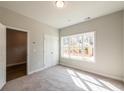 Bright bedroom with neutral carpet, natural light, and a spacious closet for comfortable living at 4822 Floydwood Ln, Mableton, GA 30126