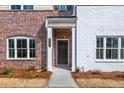Inviting front entrance with brick accents and a covered porch, creating a warm welcome at 4822 Floydwood Ln, Mableton, GA 30126
