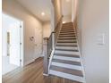 Elegant staircase with wood treads and modern railings, adding a touch of sophistication at 4822 Floydwood Ln, Mableton, GA 30126