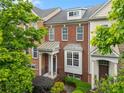 Charming townhome with brick facade, covered porch, and manicured landscaping, creating an inviting curb appeal at 4879 Seldon Se Way, Smyrna, GA 30080