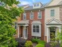 Charming townhome with brick facade, covered porch, and manicured landscaping, creating an inviting curb appeal at 4879 Seldon Se Way, Smyrna, GA 30080
