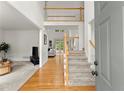 Bright foyer featuring hardwood floors, stairway and second story view at 8032 Ridge Vly, Woodstock, GA 30189