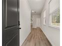 Bright entryway with hardwood floors and natural light streaming through the window at 1243 Riverstone Rd, Jonesboro, GA 30238
