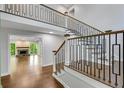 Foyer featuring modern metal and wood staircase and view into the living room with fireplace at 615 Nw Mark Trail Nw Ct, Atlanta, GA 30328