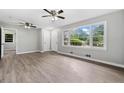 Bright living room featuring large windows, new floors, and ceiling fans providing comfort and natural light at 2078 Olive Springs Se Rd, Marietta, GA 30060