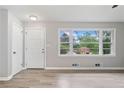 Inviting living room features a large window offering great natural light, plus new floors, and a white front door at 2078 Olive Springs Se Rd, Marietta, GA 30060