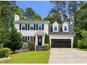 Inviting two-story home boasts a clean white facade, a dark roof, and an attached two-car garage at 300 Summer Pond Trl, Lawrenceville, GA 30046