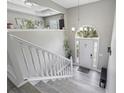 Inviting foyer with wood-look flooring, staircase, and arched doorway at 3123 Morgan Box Ln, Buford, GA 30519
