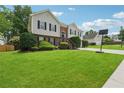 Charming two-story home with brick and siding, arched front door, manicured lawn, and a basketball hoop at 3123 Morgan Box Ln, Buford, GA 30519