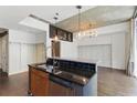 Modern kitchen island with granite countertops, stainless steel appliances, and black tile backsplash at 44 Peachtree Nw Pl # 1728, Atlanta, GA 30309