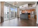 Open floor plan featuring the kitchen, hardwood floors and a large sliding glass door at 44 Peachtree Nw Pl # 1728, Atlanta, GA 30309