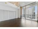 Bright, open room with hardwood floors and large windows with cityscape view at 44 Peachtree Nw Pl # 1728, Atlanta, GA 30309